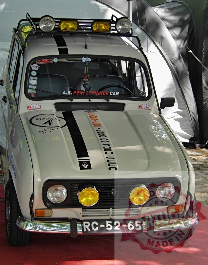 Renault 4 vintage rally car with roof rack | Renault 4 car displayed at a classic car show on a red carpet - Realized with Pictrs.com