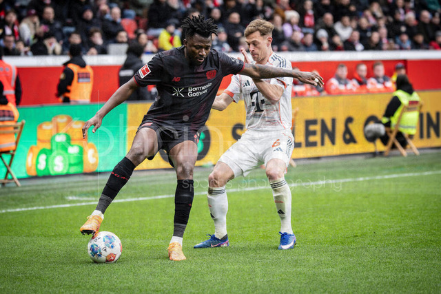 German Bundesliga, Bayer 04 Leverkusen vs. FC Bayern München, 14.03.2026 | LEVERKUSEN, GERMANY - MARCH 14:  Edmond Tapsoba (Bayer 04 Leverkusen, 12) is challenged by  Joshua Kimmich (FC Bayern Muenchen, 6) during the German Bundesliga match on gameday 26 between Bayer 04 Leverkusen vs. FC Bayern München at BayArena on March 14, 2026 in Leverkusen, Germany. DFL REGULATIONS PROHIBIT ANY USE OF PHOTOGRAPHS AS IMAGE SEQUENCES AND/OR QUASI-VIDEO.