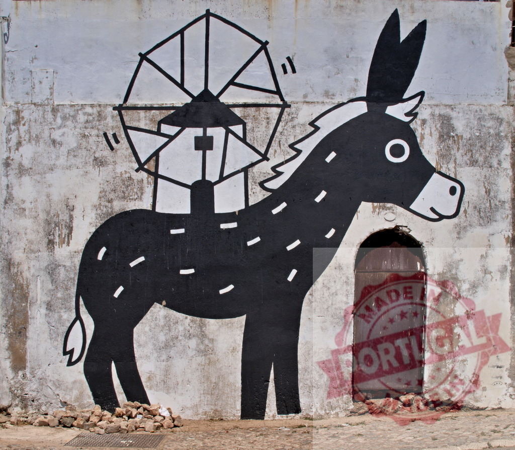 Donkey street art mural with windmill on a wall | Donkey street art mural featuring a windmill on its back painted on an old textured wall - Realisiert mit Pictrs.com