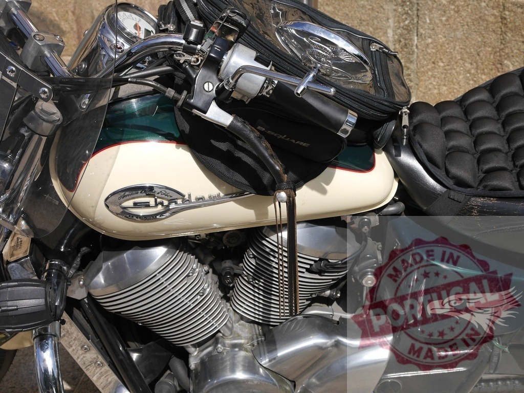 American classic motorcycle parked with tank bag and eagle sticker | Close-up of a parked vintage American motorcycle featuring a tank bag, an eagle sticker, and intricate details - Realized with Pictrs.com