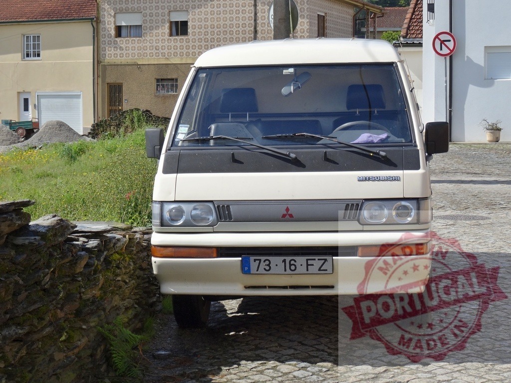 Mitsubishi van parked on Portuguese cobblestone road | Mitsubishi van parked on a cobblestone street in a rural Portuguese village - Realized with Pictrs.com