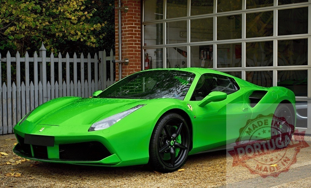 Shiny green Ferrari 488 Pista parked in front of garage | Luxurious green Ferrari 488 Pista parked in front of a garage, showcasing its sleek design and vibrant color - Realisiert mit Pictrs.com