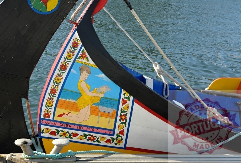 Moliceiro boat prow painting showing woman reading book in Aveiro, Portugal | Traditional Moliceiro boat prow with folk art painting of a woman and humorous text - Realized with Pictrs.com