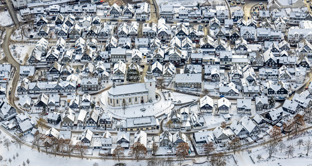 Winterberg221201467-2 | Luftbild Innenstadt mit kath. Kirche St. Jakobus der Ältere, schneebedeckte Häuser, Winterwunderland in Winterberg im Sauerland, am Kahlen Asten und den Skiabfahrten und dem Skilift-Karussell Winterberg, Winterberg, Sauerland, Nordrhein-Westfalen, Deutschland