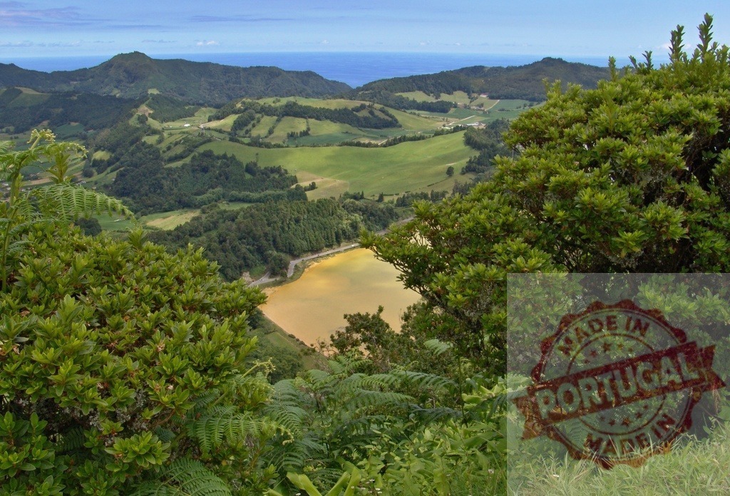 Looking down at Lagoa das Furnas caldera lake, São Miguel, Azores | Verdant hills and a volcanic lake framed by lush vegetation, with the Atlantic Ocean in the distance - Realized with Pictrs.com