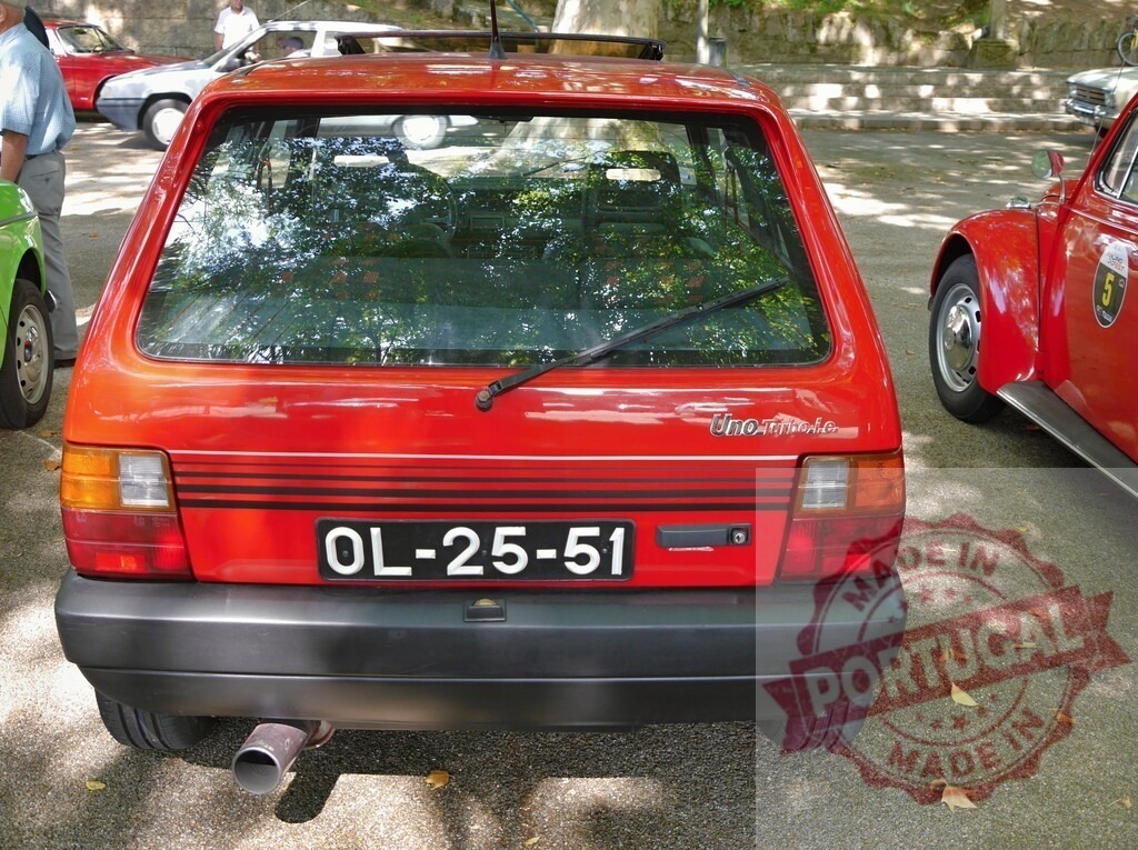 Fiat Uno Turbo i.E. Hatchback rear view at vintage car show | Fiat Uno Turbo i.E. Compact hatchback displaying its rear at an outdoor car exhibition - Realized with Pictrs.com