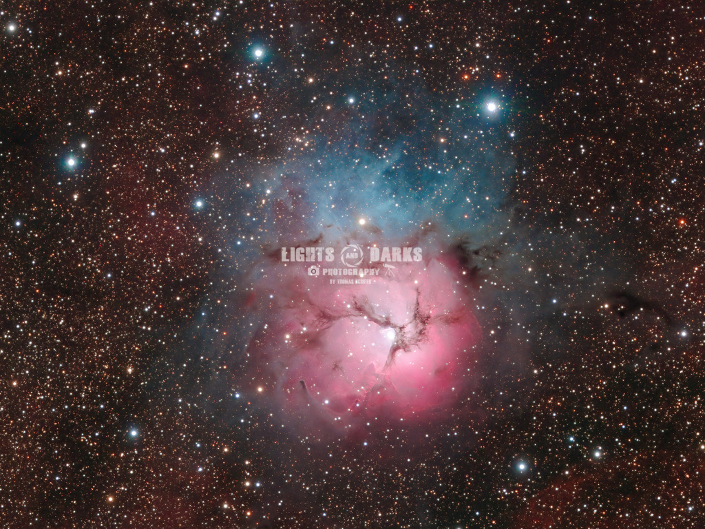 The Trifid Nebula | The Trifid Nebula (M20) is part of the so called Saggitarius Triplet and sits in the middle of the center of our galaxy. It is an unusual combination of an open cluster of stars, an emission nebula (the reddish-pink part), a reflection nebula (the blue portion), and a dark nebula (the apparent 'gaps' in the former that cause the trifurcated appearance, also designated Barnard 85 from Wikipedia).

This is the natural colour palette. Normally I am of the opinion that we amateur astro photographers are more into doing art than science - so the colour is a little bit of artistic freedom. espescially when doing narrow band imaging. However this object is really beautiful and I had enough high quality broadband data so I decided to spectro photometric colour calibrate it to get the coulors as natural as possible.

Shot only with an IR-UV blocking filter from Kiripotib in Namibia. - Realisiert mit Pictrs.com
