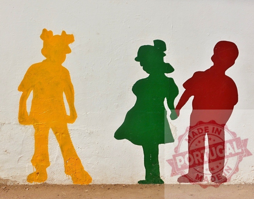 Children silhouettes mural showing jealousy and friendship | Colorful children silhouettes painted on a white wall illustrating social dynamics during childhood - Realized with Pictrs.com