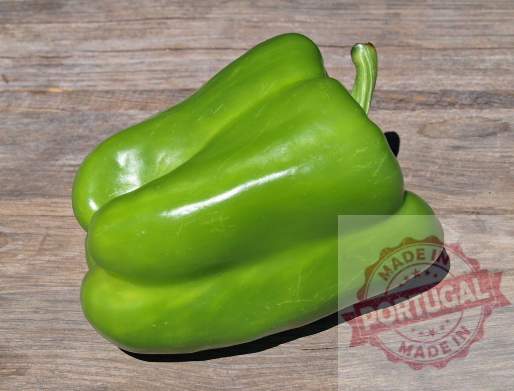 Green bell pepper vegetable on rustic wood surface | Green bell pepper resting on a textured wooden background - Realized with Pictrs.com