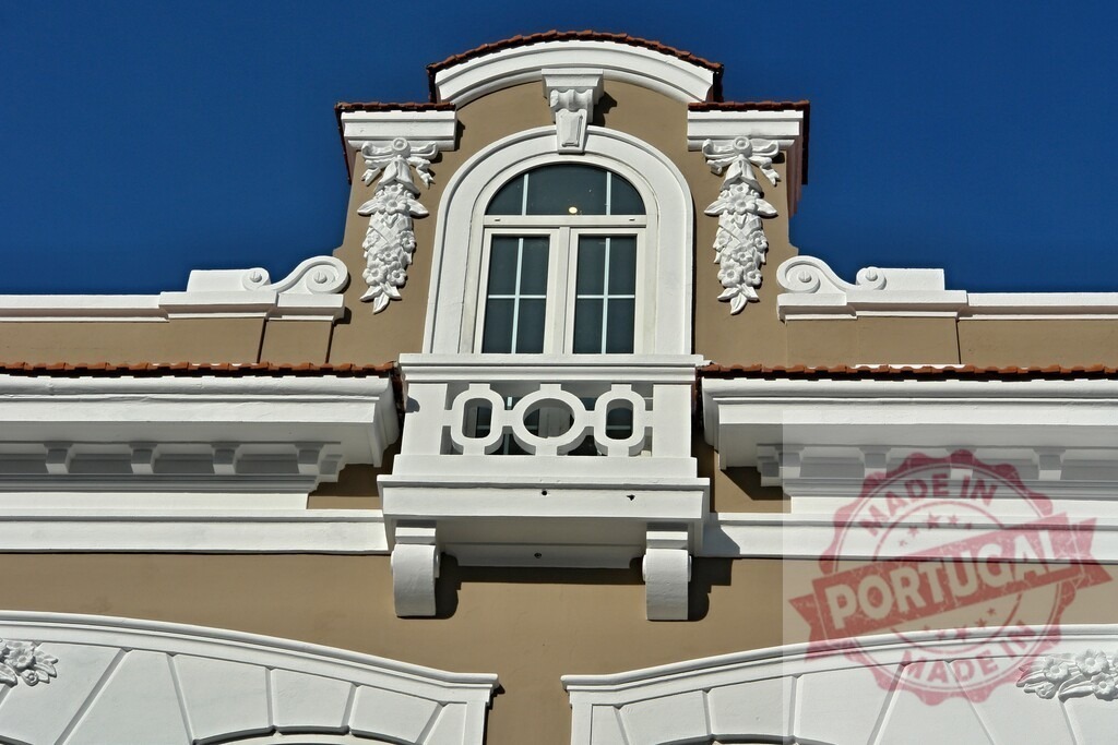 Ornate architectural facade featuring rococo style window and balcony | Building showing detailed window and balcony with white stucco decoration under blue sky - Realized with Pictrs.com