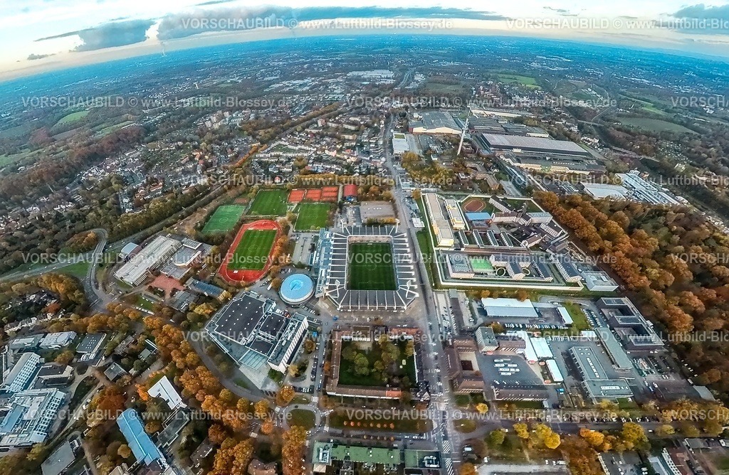 Bochum231190090RuhrStadion-topaz | Luftbild, Vonovia Ruhrstadion Bundesligastadion des VFL Bochum 1848 an der Castroper Straße, Justizvollzugsanstalt Bochum, Rundsporthalle und Trainingssportplätze, RuhrCongress Halle, Starlight Express Musical Eventhalle, Autobahn A40, rechts der Fernmeldeturm Bochum, Wohngebiet und Gewerbegebiet mit thyssenkrupp Steel AG Bochum, umgeben von herbstlichen Laubbäumen, Landeserstaufnahmeeinrichtung für Flüchtlinge NRW in Bochum. Erdkugel, Fisheye Aufnahme, Fischaugen Aufnahme, 360 Grad Aufnahme, tiny world, little planet, fisheye Bild, Grumme, Bochum, Ruhrgebiet, Nordrhein-Westfalen, Deutschland