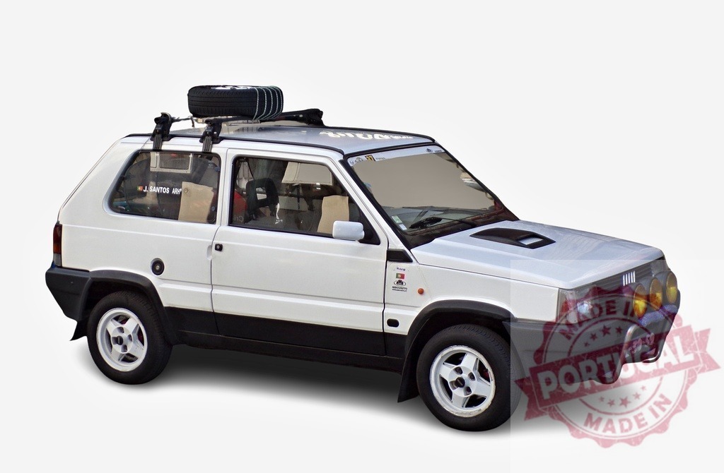 White Fiat Panda 4x4 Sisley sporting roof rack and auxiliary lights | Customized white Fiat Panda 4x4 Sisley with a roof rack carrying a spare tire and auxiliary lights, ready for adventure - Realized with Pictrs.com