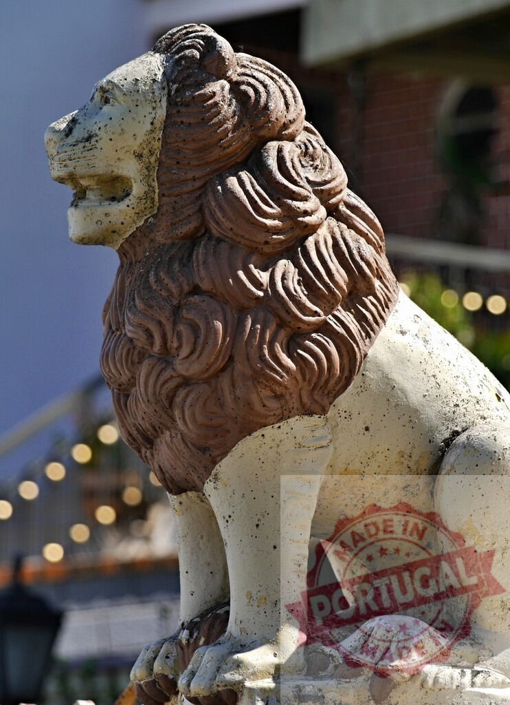 Stone lion statue representing strength and protection | Weathered stone lion statue with a brown mane seated outdoors - Realized with Pictrs.com