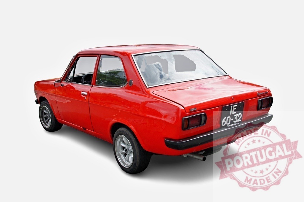 Classic red Datsun Sunny 1200 Coupe parked on a white background | Red Datsun Sunny 1200 Coupe from the seventies, parked and shining, is waiting for a ride - Realized with Pictrs.com