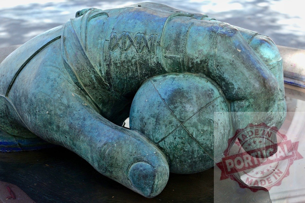 Bronze hand holding DNA helix sphere | Bronze hand sculpture holding an orb with genetic code pattern, symbolizing creation and science - Realized with Pictrs.com