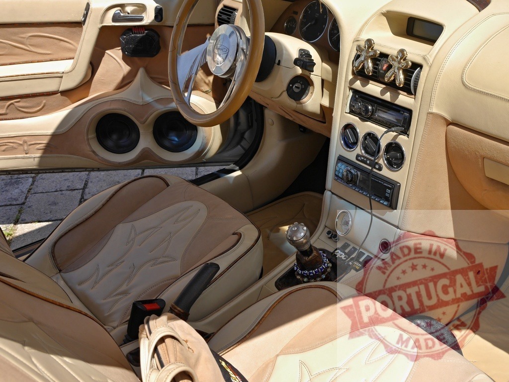 Customized luxury car interior with beige leather upholstery | Car interior showing customized leather design, steering wheel, dashboard, and audio system - Realized with Pictrs.com
