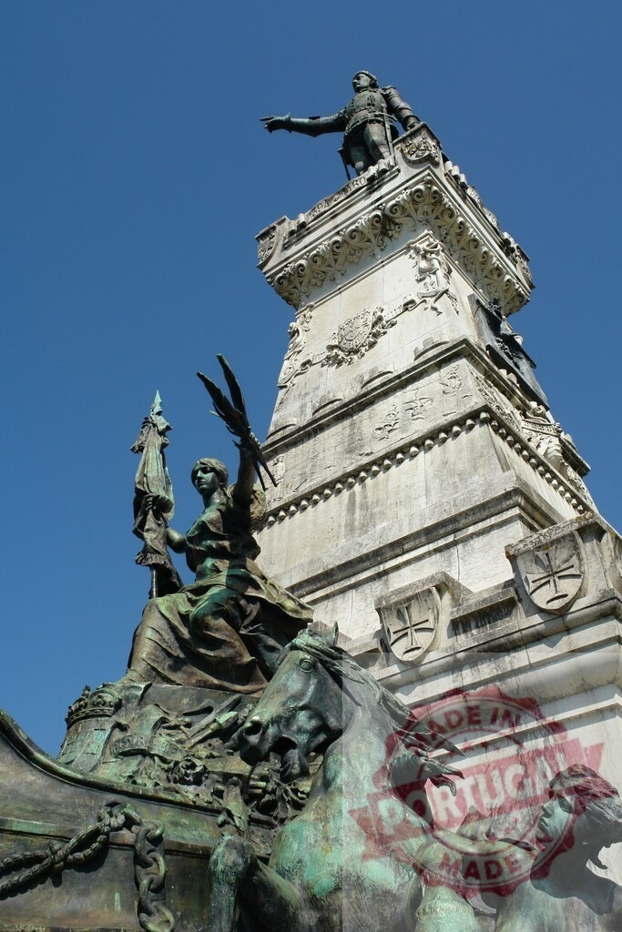 Prince Henry the Navigator statue in Porto, Portugal. Porto - Portugal | Statue of Prince Henry the Navigator pointing towards the horizon with allegorical figures below - Realized with Pictrs.com