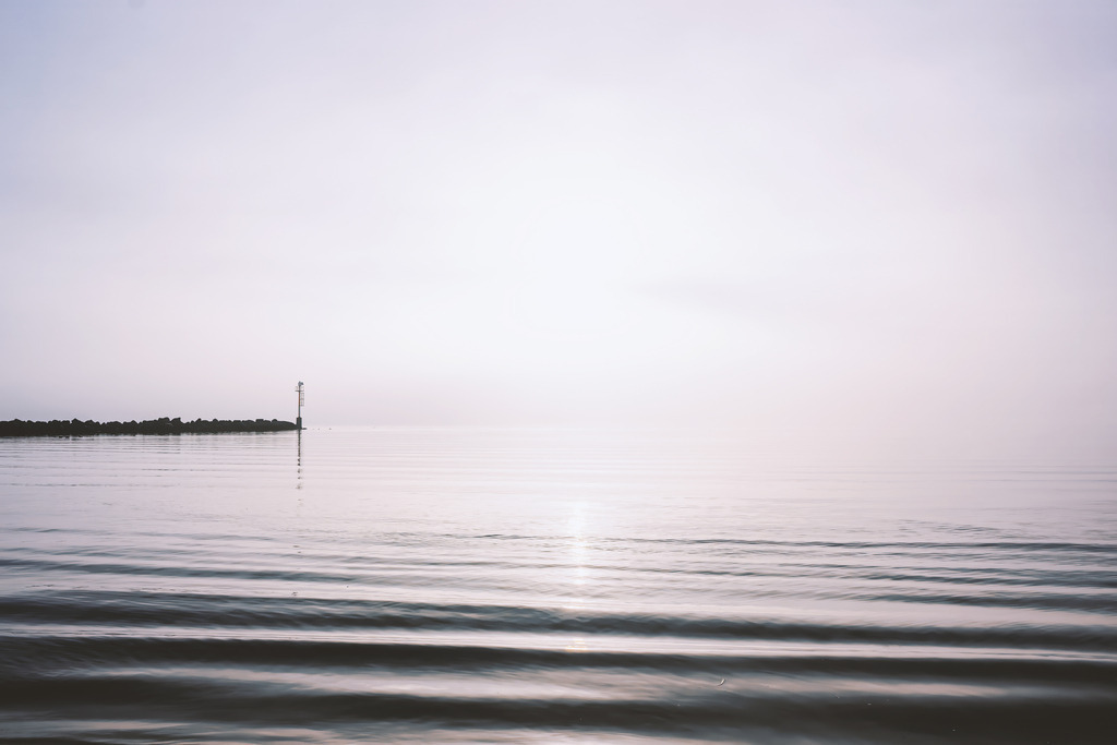 Wandbild: Morgenlicht über der Ostsee – Damp in sanften Farben | Dieses maritime Wandbild zeigt die Ostsee im frühen Morgenlicht, in dem Wasser und Himmel in weichen, hellen Tönen ineinander übergehen. Die klare Horizontlinie und das zarte Leuchten über der Wasserfläche verleihen dem Motiv eine offene, leichte Stimmung. Die Aufnahme betont den Moment, in dem der Tag beginnt und das Licht die Weite des Meeres sanft hervorhebt – eine stille, lichtbetonte Szene aus Damp, die nordische Frische und eine reduzierte, atmosphärische Bildsprache transportiert.