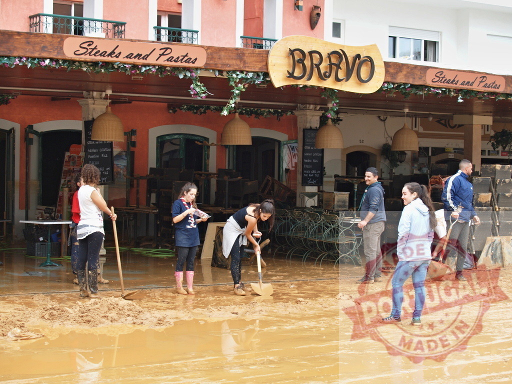 Volunteers cleaning restaurant after natural disaster flood mud | Albufeira Flood - discruction by weather problems Community volunteers cleaning mud and debris from a restaurant after a natural disaster flood - Realized with Pictrs.com
