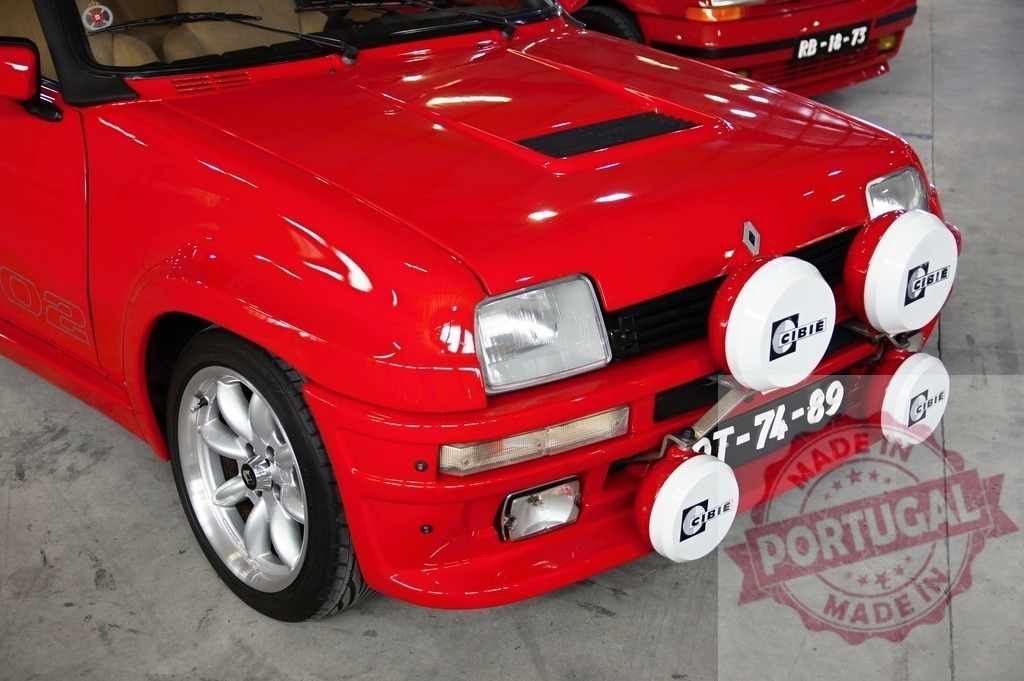 Red Renault 5 GT Turbo phase 2 showing front fog lights | Close-up of a red Renault 5 GT Turbo phase 2 parked, showing Cibie fog lights - Realized with Pictrs.com