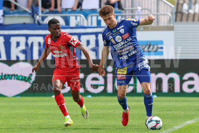 TSV Egger Glas Hartberg vs SK Rapid Wien – Championship Group    | Hartberg, Austria, 19.Apr.26 - SOCCER - ADMIRAL Bundesliga, TSV Egger Glas Hartberg vs SK Rapid Wien. The image shows Romeo Amane (SK Rapid Wien) and Marco Hoffmann (Hartberg). 