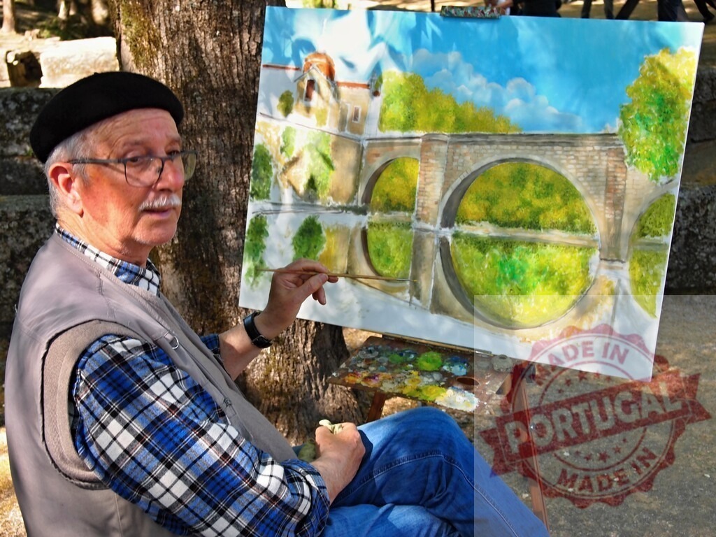 Senior artist painting watercolor landscape outdoors on easel | Senior man painting an arched stone bridge reflecting in water on canvas in an outdoor setting - Realized with Pictrs.com