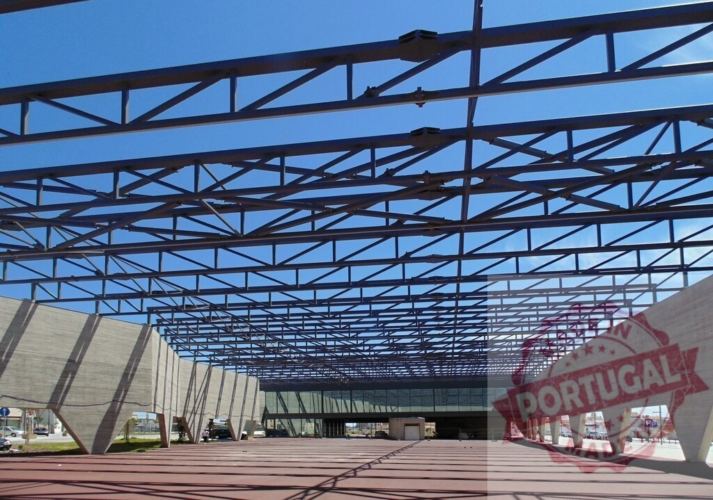Modern architecture steel frame structure under blue sky. Aveiro - Portugal | Geometric steel truss and concrete walls forming a large, open construction - Realized with Pictrs.com