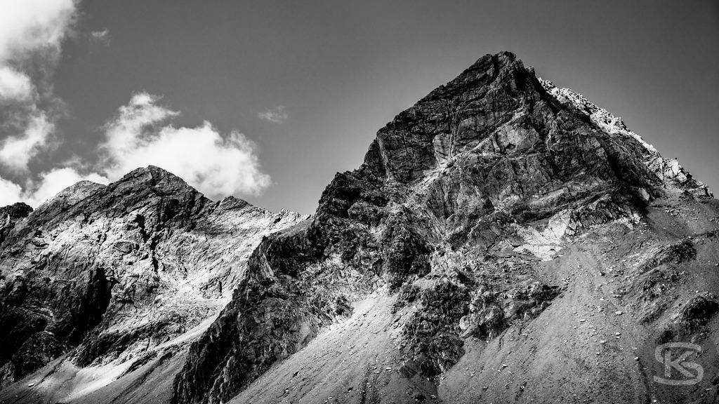 Blick auf die Schesaplana - Rätikon Gebirgsmassiv Vorarlberg, Graubünden | Majestätischer Blick auf das Gebirgsmassiv im Rätikon. Monumentales Schwarzweiß-Foto mit dramatischem Himmel. Die Schesaplana, höchster Gipfel des Rätikon-Massivs erhebt sich über schroffe Geröllhänge und beeindruckt mit seiner markanten Felsformation an der Grenze zwischen Vorarlberg und Graubünden. - Realisiert mit Pictrs.com