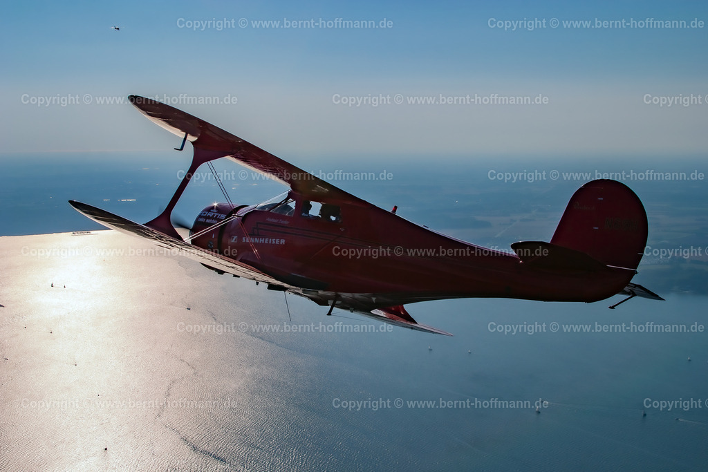 PLB_BC-Staggerwing_117_1798mod_105x70 | LUFTBILD. Historischer Doppeldecker Typ Beechcraft Staggerwing über der Flensburger Förde - südlich von Kollund (Dänemark) - Realisiert mit Pictrs.com