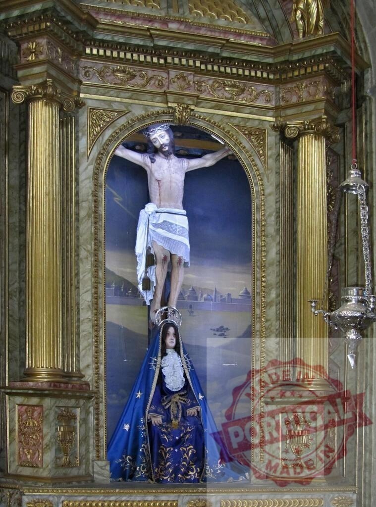 Jesus Christ on the cross with Virgin Mary statue in a church | Wooden statue of Jesus Christ on the cross with a statue of the Virgin Mary at his feet inside an ornate church - Realisiert mit Pictrs.com