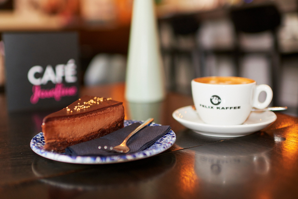 Cafe Josefine | WIen, Austria - February 13, 2018: Cafe Josefine; Blick in das Cafe-auf dem Tisch stehend eine Chocolate de Luxe Torte mit einer Tasse Felix Kaffee und einer Speisekarte. - Realisiert mit Pictrs.com