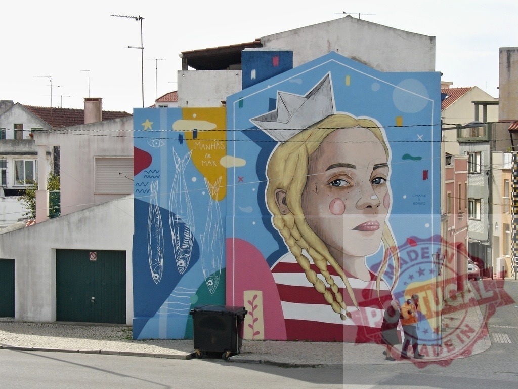 Woman with paper boat hat mural in urban street | Street art mural featuring a woman wearing a paper boat hat, fish, and text on a building wall - Realisiert mit Pictrs.com