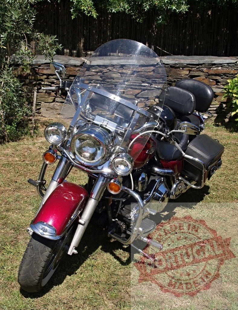 Powerful Harley-Davidson Road King Classic Motorcycle Parked on Grass | Burgundy Harley-Davidson Road King Classic motorcycle parked on a grass field, showcasing its chrome details and windshield - Realized with Pictrs.com