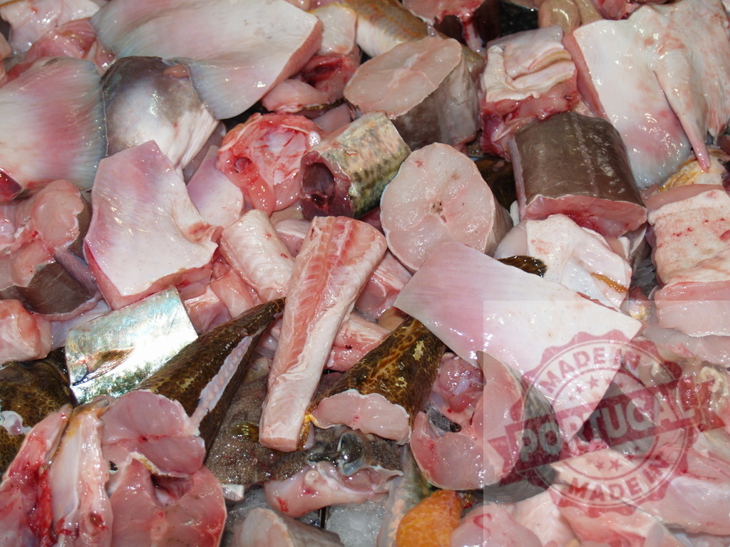 Fresh raw seafood pieces ready for cooking | Raw fish and seafood pieces piled together at a market stall for sale - Realized with Pictrs.com