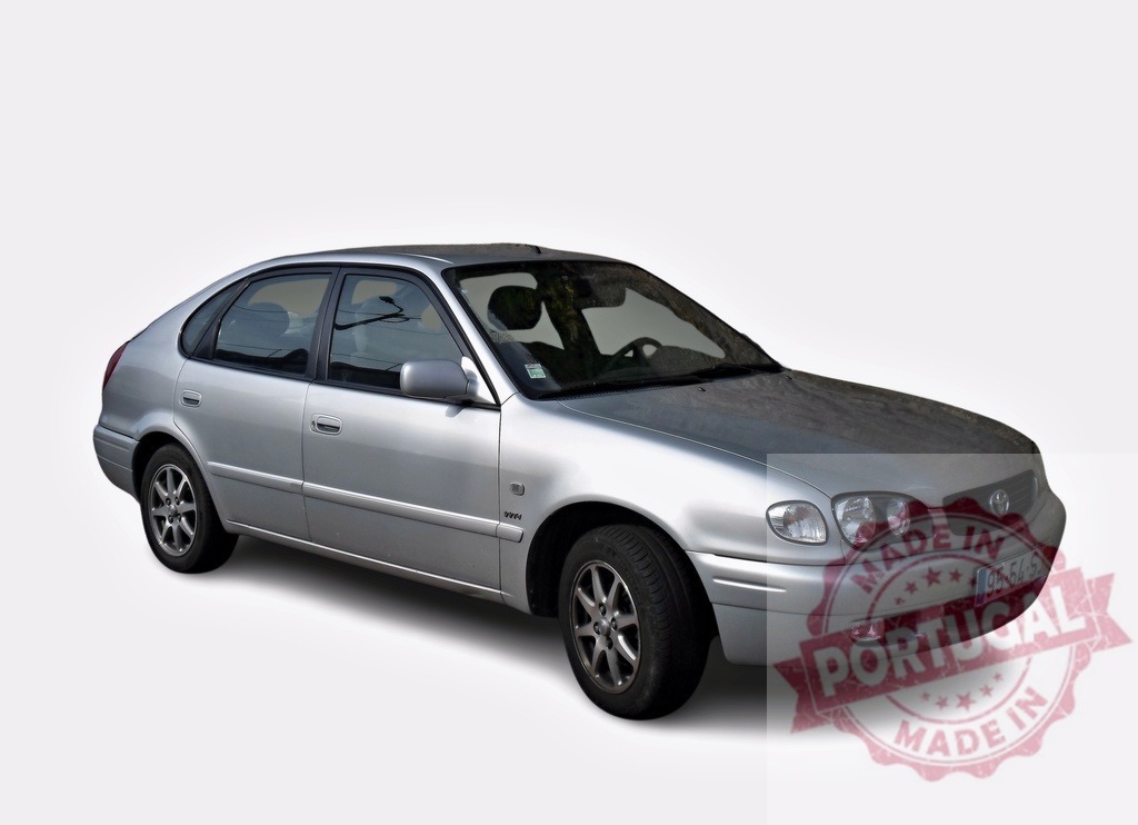 Silver Toyota Corolla E11 Hatchback parking on white background | Three-quarter view of a silver Toyota Corolla E11 Hatchback parking on a white background, showcasing its exterior design - Realized with Pictrs.com