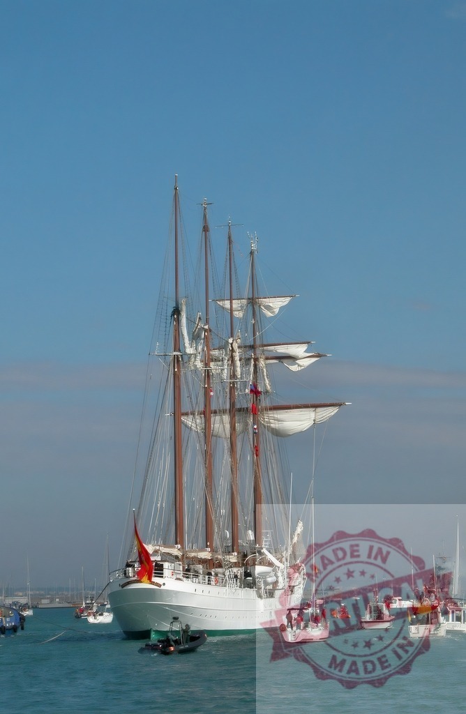 Juan Sebastián de Elcano training ship sailing the high seas. Espana - Cadiz | Juan Sebastián de Elcano, a Spanish navy tall ship, sailing on blue waters - Realized with Pictrs.com
