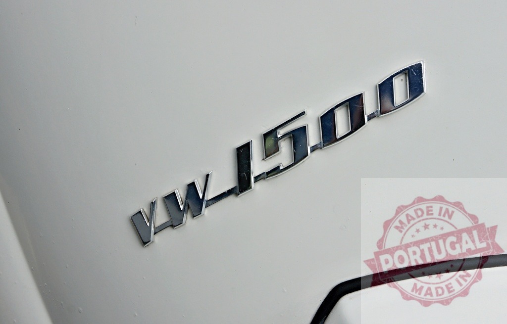 VW 1500 Volkswagen classic car chrome emblem close up | VW 1500 model chrome emblem on a white vintage Volkswagen car - Realized with Pictrs.com