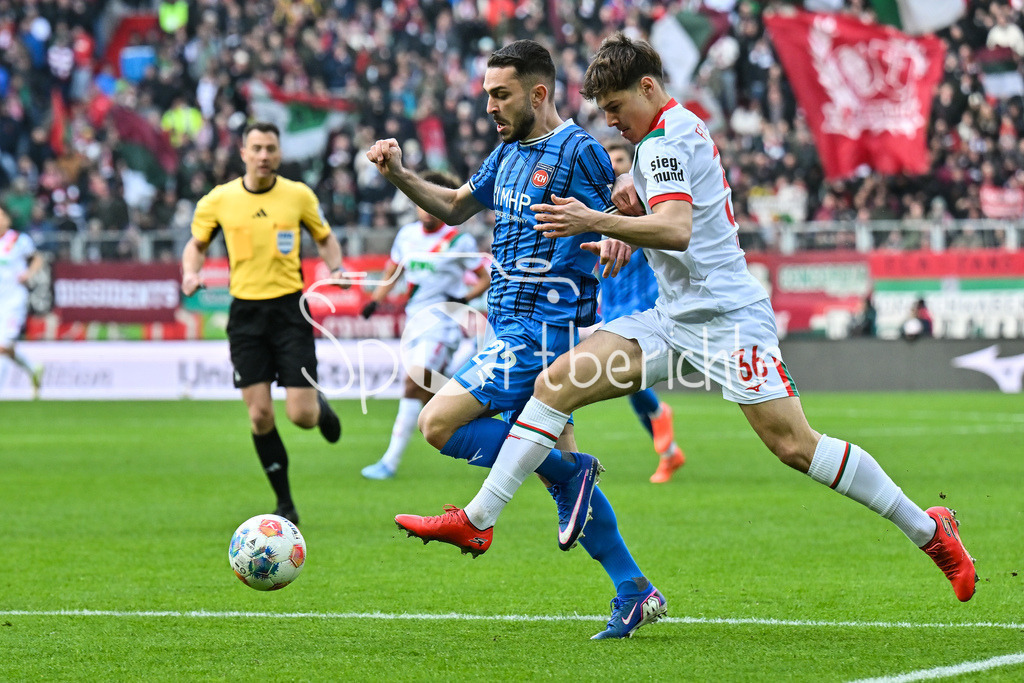 FC Augsburg - 1. FC Heidenheim | AUGSBURG, GERMANY - 15. FEBRUARY: im DUell Arijon IBRAHIMOVIC (1. FC Heidenheim 22) und Mert KOEMUER (KÖMÜR, KOMUR, FC Augsburg 36) während dem Bundesligamatch zwischen dem FC Augsburg und dem 1. FC Heidenheim am 22. Spieltag in der WWK-Arena / DFL REGULATIONS PROHIBIT ANY USE OF PHOTOGRAPHS AS IMAGE SEQUENCES AND/OR QUASI-VIDEO