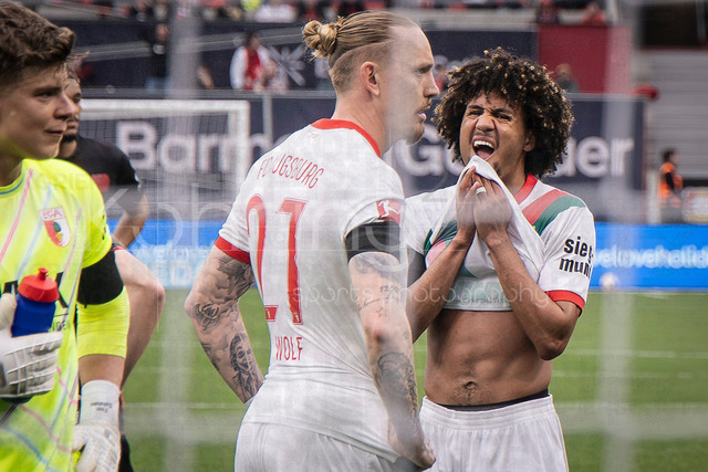 German Bundesliga, Bayer 04 Leverkusen vs. FC Augsburg, 18.04.2026 | LEVERKUSEN, GERMANY - APRIL 18, 2026 :  Rodrigo Ribeiro (FC Augsburg, 21) and Han-Noah Massengo (FC Augsburg, 4) during the German Bundesliga match on gameday 30 between Bayer 04 Leverkusen vs. FC Augsburg at BayArena on April 18, 2026 in Leverkusen, Germany. DFL REGULATIONS PROHIBIT ANY USE OF PHOTOGRAPHS AS IMAGE SEQUENCES AND/OR QUASI-VIDEO.