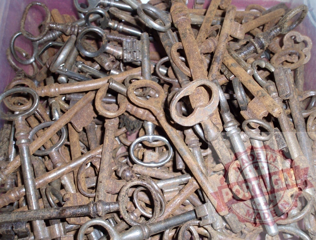 Pile of old skeleton keys showing secrets and access | Stack of antique skeleton keys with rust creating a vintage background - Realized with Pictrs.com