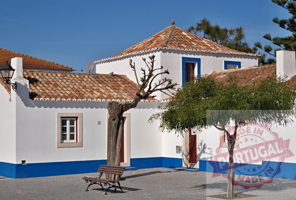 Portuguese traditional village houses with blue trim and terracotta roofs | Whitewashed Portuguese village houses with terracotta tiled roofs and blue details under a clear sky - Realisiert mit Pictrs.com
