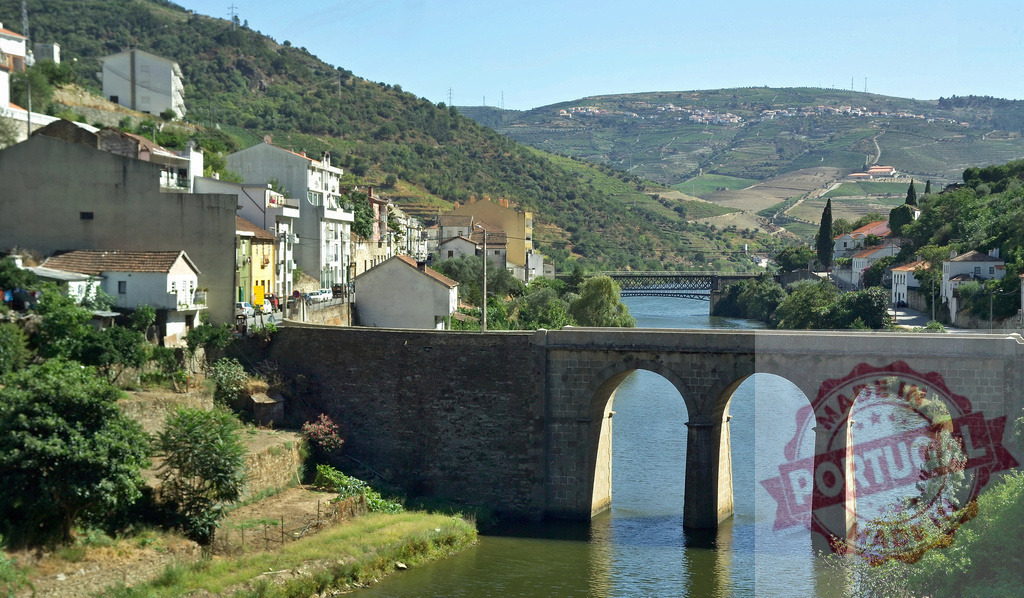 Pinhão village with bridges crossing Douro River valley | Pinhão village showing historic and railway bridges spanning the Douro river - Realized with Pictrs.com