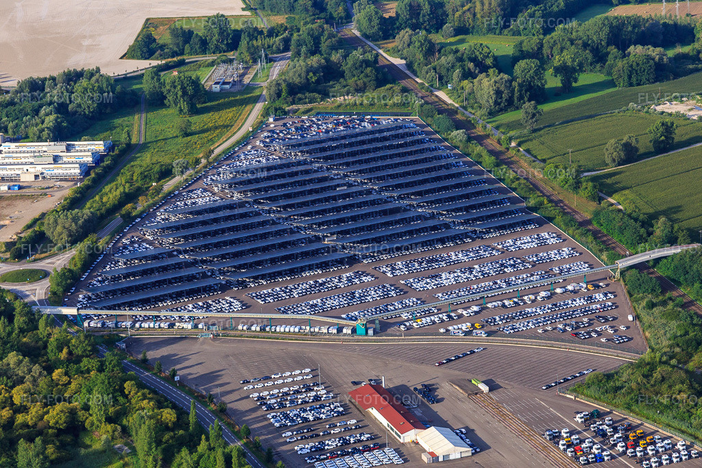 Aerial view: ARCHICUB - Parking area for the import of trucks and cars by Walon in Lauterbourg in the state Bas-Rhin, France. – Photo: IMG_149485.jpg taken on 08/09/2025 by Werner Riehm/FLY-FOTO.com – Resolution of the original: 5472 x 3648 px – Solutions logistiques pour l'industrie:
