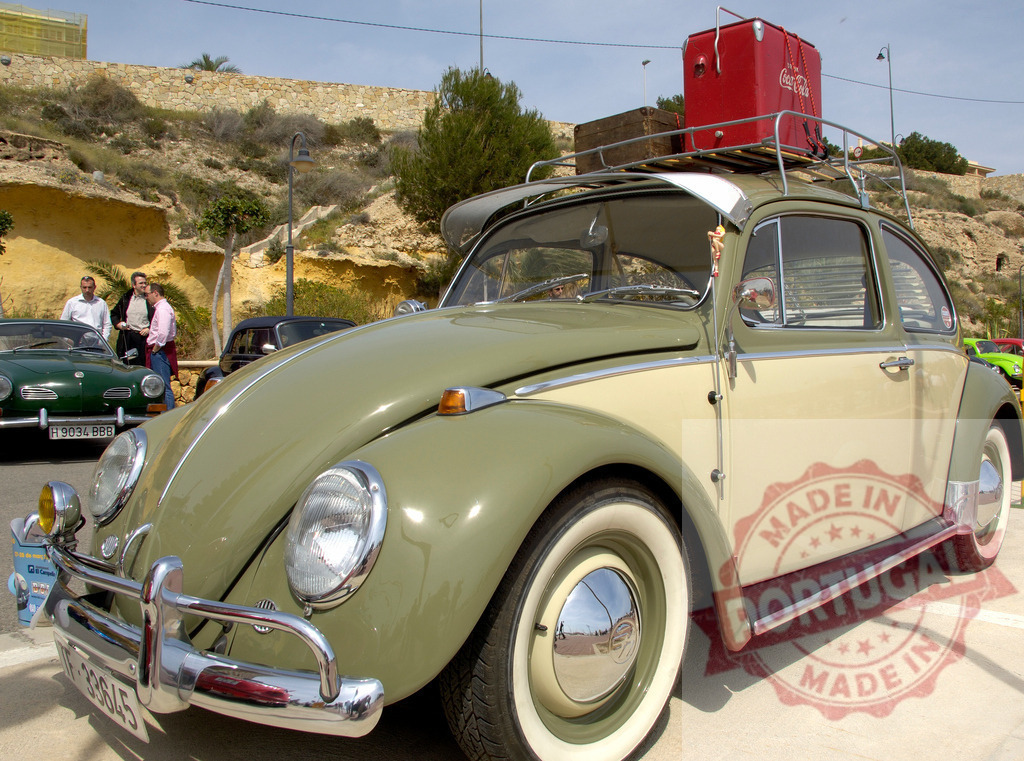 Classic Volkswagen Beetle parking with Coca-Cola cooler on roof rack | Restored Volkswagen Beetle with Coca-Cola cooler on roof rack parking near other classic cars - Realized with Pictrs.com