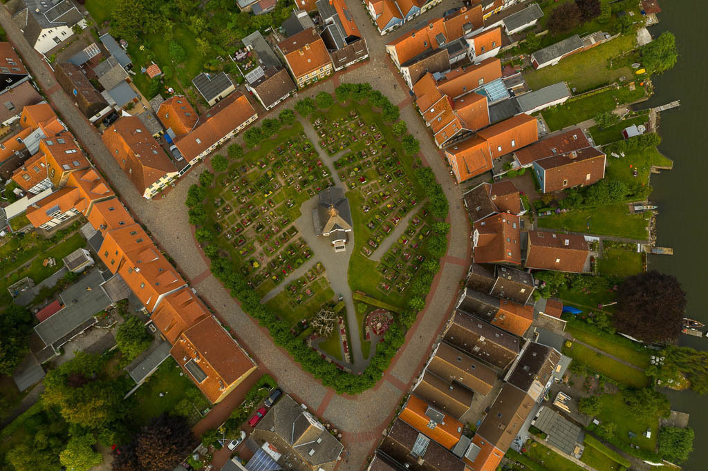 zeitenwende-farbe-01-19 | Blick auf die Fischersiedlung Holm in Schleswig mit Friedhof und Kapelle im Zentrum - Realisiert mit Pictrs.com