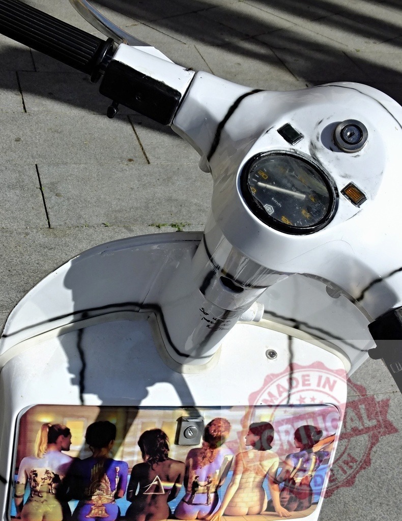 Vintage scooter showcasing Pink Floyd's back cover of their album Wish You Were Here | White vintage scooter with iconic Pink Floyd album cover decoration parked on a paved area - Realisiert mit Pictrs.com