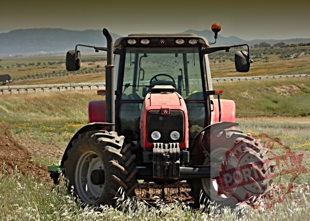 Red Massey Ferguson tractor plowing rural field | Red agricultural tractor working field with farm equipment and highway in background - Realized with Pictrs.com