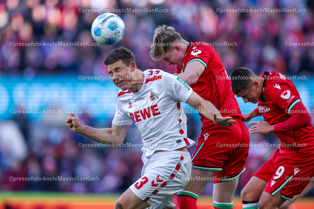 1FC30112401025 | 30.11.2024, Fußball, 1. FC Köln - Hannover 96, 2. Fußball Bundesliga, RheinEnergieSTADION, Saison 2024 2025: Zweikampf Kopfball Dominique Heintz (1.FC Köln #3) gegen Josh Knight (Hannover #2) und Nicolo Tresoldi (Hannover #9)DFB regulations prohibit any use of photographs as image sequences and or quasi-video.