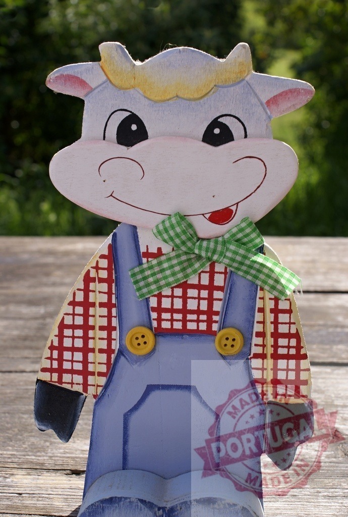 Hand painted wooden cow figurine wearing overalls | Wooden cow figurine wearing checkered shirt and blue overalls with a green bow tie - Realized with Pictrs.com