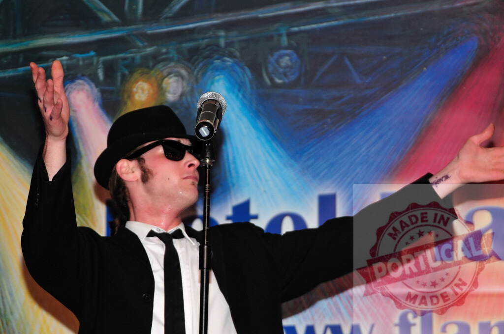 Blues Brothers tribute band singer performing live on stage | Impersonator performing a live music concert as a Blues Brothers character - Realized with Pictrs.com